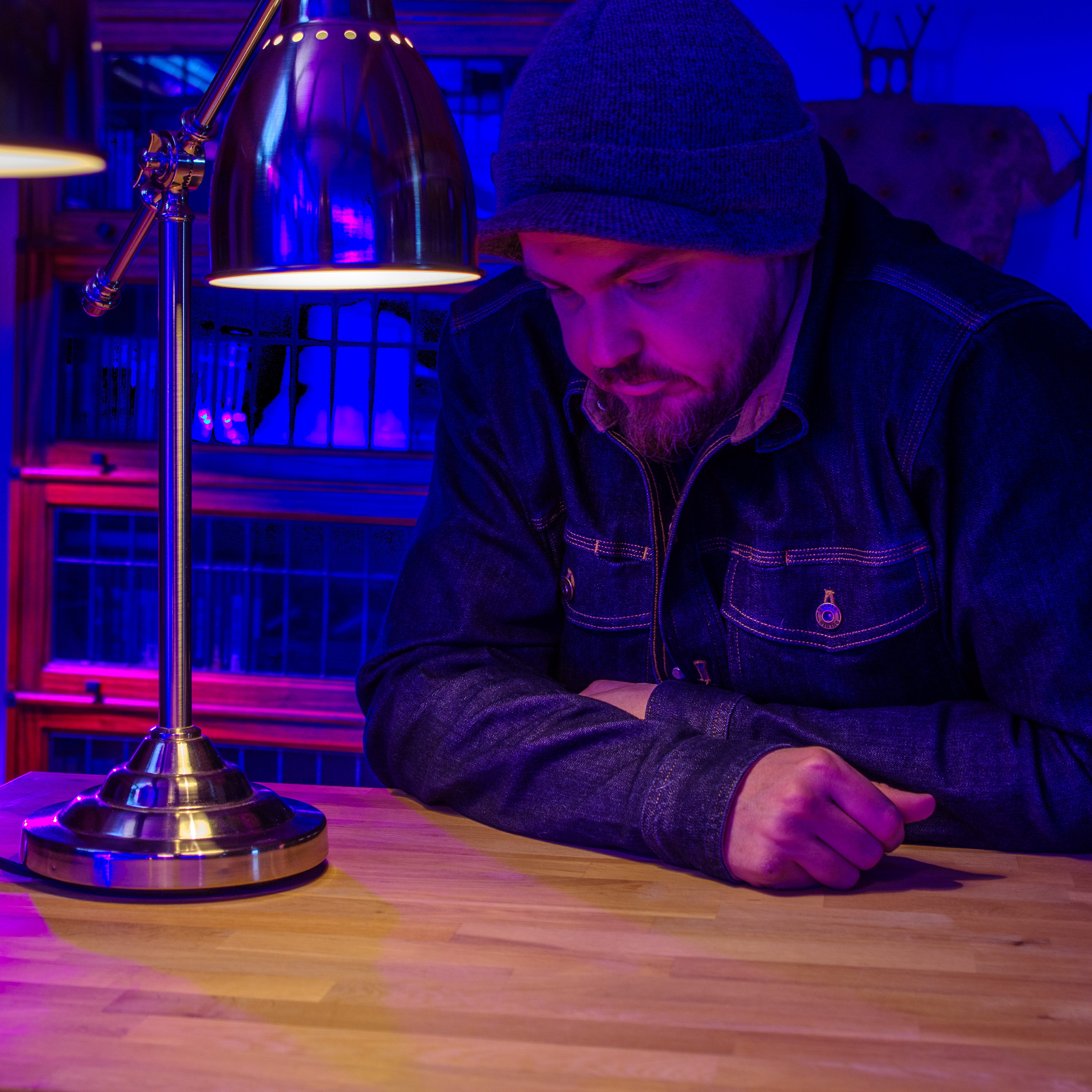 A reflective SW Hammond looking downward. Candid. Cool blue and purple lighting fills the background.