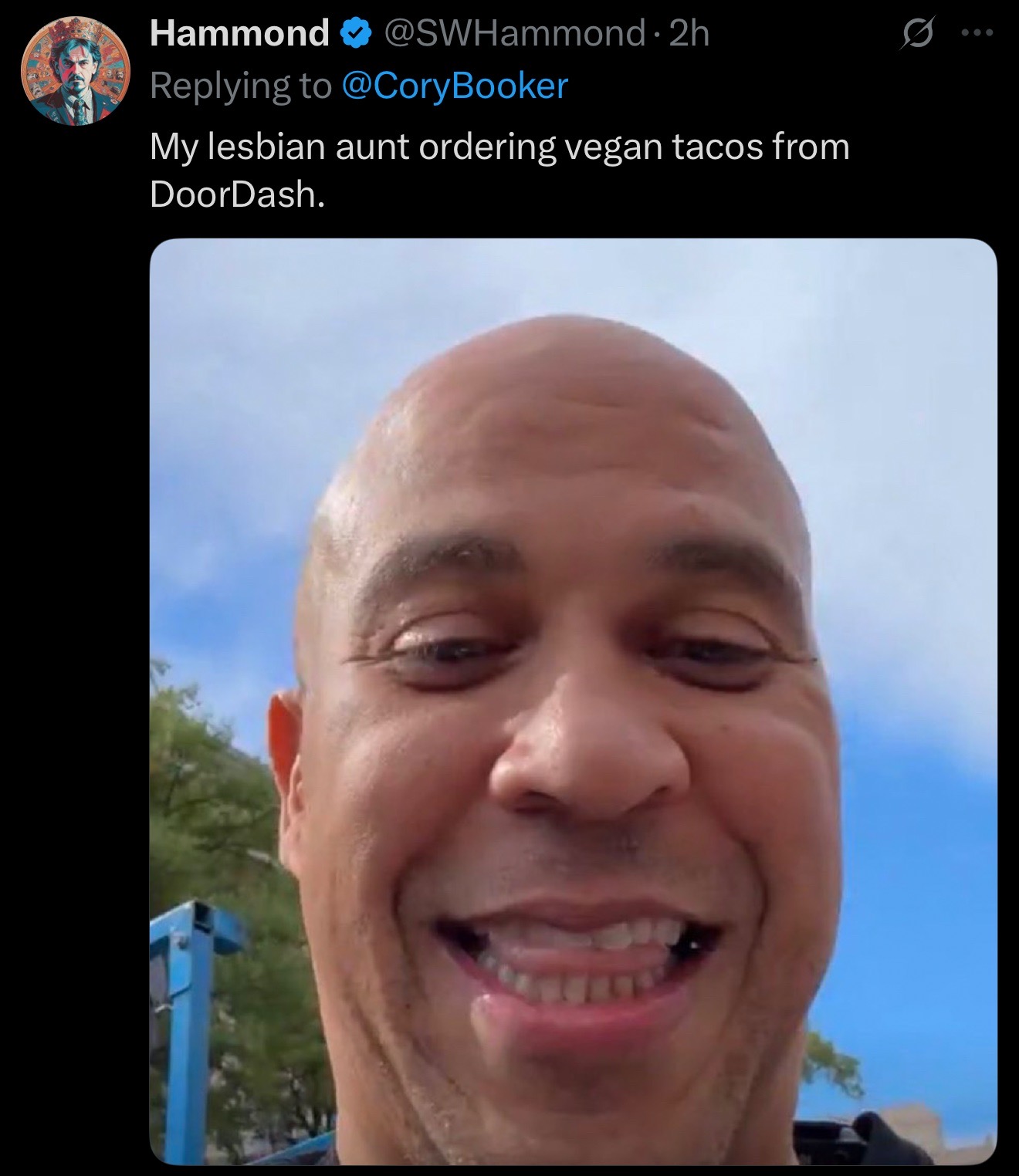 Cory Booker with a creepy smile looking into the camera of his phone with a caption that reads, "My lesbian aunt ordering vegan tacos from DoorDash."